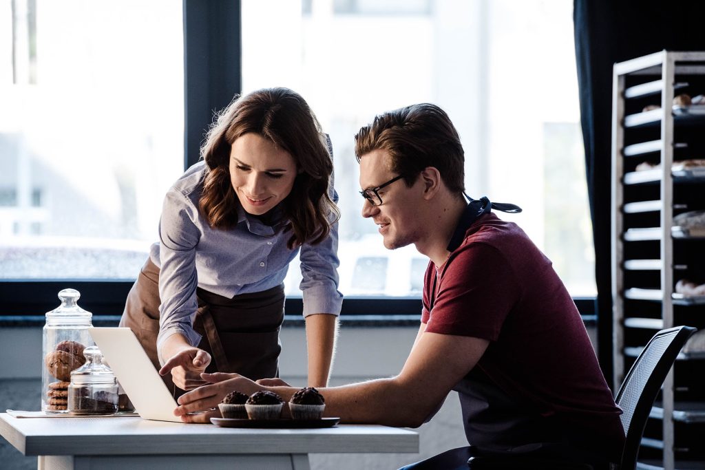 two people looking at computer